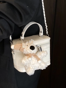 Structured white box bag with woven leather texture and cute plush bear charm