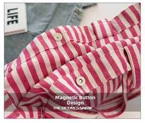 Detailed macro view of pink striped canvas tote bag featuring secure silver magnetic snap closure