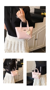 Detailed view of a pink bucket bag featuring a pearl heart charm and versatile strap options
