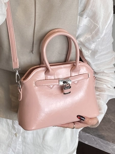 Elegant pink glossy shell bag with silver padlock and top handles for women