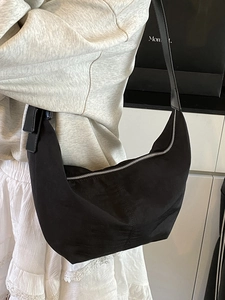 Minimalist black nylon crescent hobo bag with a sleek waterproof finish and silver zipper