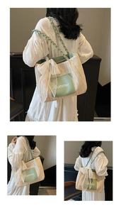 Detail of woven tote bag with green Summer tag and delicate white lace bow accent