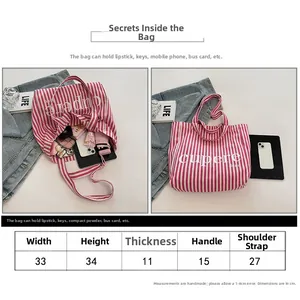 Detailed size chart and capacity overview of striped canvas tote bag with dual straps