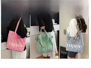 Detailed views of striped canvas tote bags in pink, green and navy blue colors