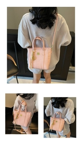 Close-up of pink PU leather bucket bag with embossed animal patterns and woven tassel