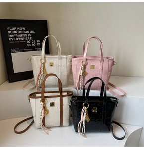 Detailed view of embossed PU bucket bags with cute rabbit patterns and metal charms
