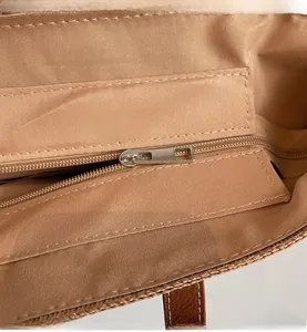 Detailed macro view of smooth silver metal zipper and durable khaki fabric inner lining