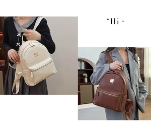 Close-up of minimalist leather backpacks in cream and brown with metal logo and zipper detail