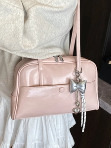 Pink glossy faux leather Boston bag with bow charm and silver zipper for women