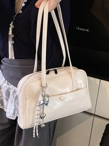 Chic cream-white oil wax leather Boston bag with bow pendant and dual handles