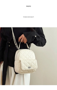 Close-up of white quilted mini backpack featuring silver chain strap and metal turn-lock