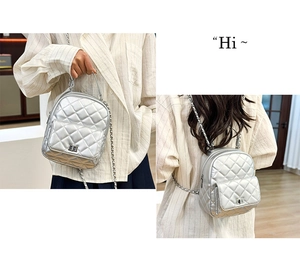 Detail showing silver quilted leather mini backpack with chain strap in dual carry modes