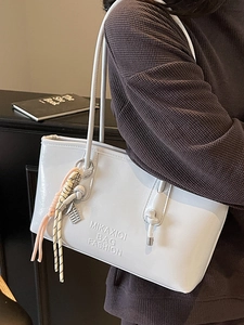 Chic light gray large bucket bag for women with shoulder strap in a lifestyle setting