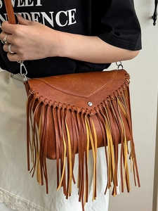Vintage brown fringe crossbody bag with woven edges and faux leather lychee texture