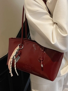 Minimalist deep red patent leather bucket bag with large capacity and woven rope charm