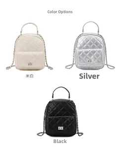 Close-up of quilted chain backpack in cream, silver, and black with metal hardware