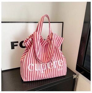 Detailed view of pink striped canvas tote bag texture with cupere printed text