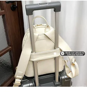 Detail view of cream leather backpack with built-in trolley sleeve for suitcase travel
