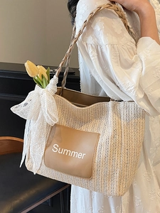 Beige woven straw tote bag with brown rope handles and summer leather patch detail