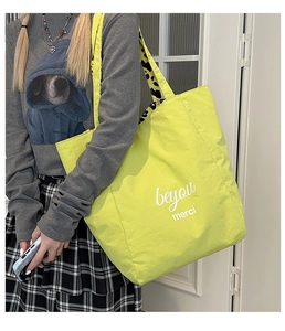 Detail of neon green tote bag showing double-sided leopard print lining and logo