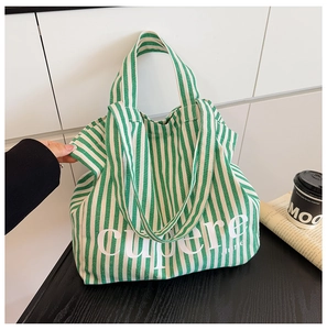 Detail of green and white striped canvas tote bag with white cupere letter printing