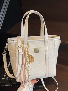 Chic cream white bucket bag with cute embossed animals and gold tennis racket charm