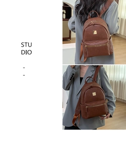 Detailed view of brown retro backpack with gold zipper pocket and smooth leather texture