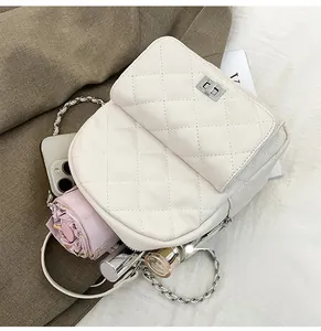Top view of white quilted mini backpack interior showing capacity for daily essentials