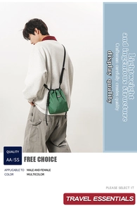 Detail of lightweight green plaid nylon drawstring crossbody bag with adjustable black strap