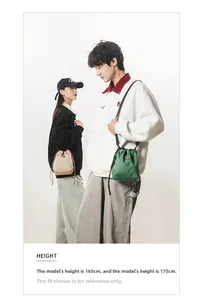 Detail view of lightweight beige and green checkered crossbody bags on male and female models