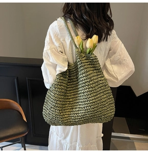 Detail of green straw woven tote bag with tulip flower showing French cottage style