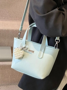 Chic mint blue bucket bag with pearl heart charm and crossbody strap for women