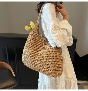 Detailed close-up of a large capacity straw tote bag with intricate woven fiber texture