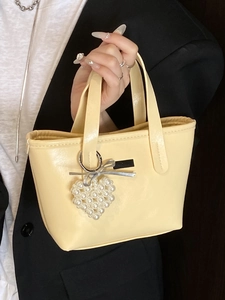 Minimalist light yellow PU leather mini bucket bag with pearl heart and bow charm details