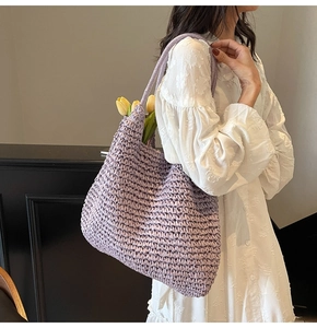 Detail of lavender crochet woven tote bag featuring a textured finish and long shoulder strap