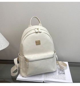 Detail of minimalist beige faux leather backpack with gold MKBV plate and zipper pocket