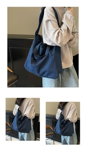 Detailed close-up showing the deep blue denim texture and stitching of large tote bag