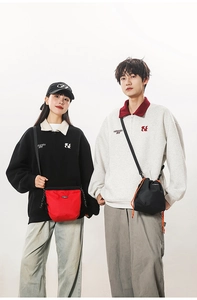 Detail of red and black checkered crossbody phone bags with drawstring closure and cord straps