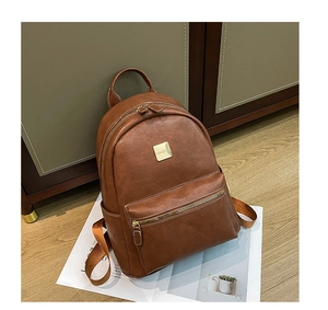 Close-up of brown PU leather backpack with silver MKBV metal logo and zipper detail