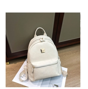 Detailed macro view of gold MKBV metal nameplate on cream PU leather backpack bag