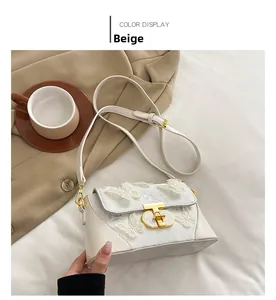 Detail of beige crossbody bag featuring 3D butterfly lace and golden metal T-lock