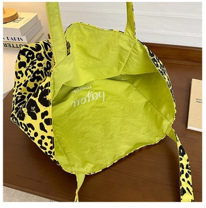 Top view of leopard print tote bag showing bright green lining with be you text detail