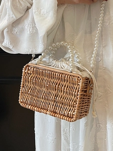 Chic woven rattan box bag with pearl handle and crossbody chain for casual summer vacations
