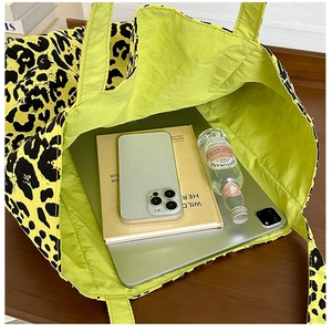 Top view of large leopard print tote bag interior showing spacious storage for iPad and books