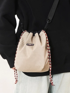 Plaid canvas drawstring bucket crossbody bag with adjustable strap for sports style