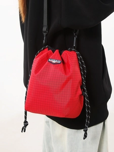 Fashionable red plaid drawstring crossbody phone bag with adjustable black nylon strap