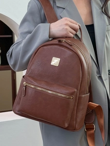 Retro brown leather backpack for women with adjustable straps and metallic logo plate