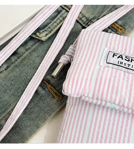 Detailed macro view of the pink striped fabric texture and the Fashion textile label