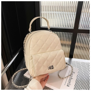 Detailed macro view of quilted cream PU leather mini backpack with silver metal buckle
