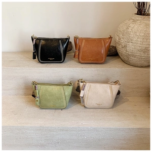 Detail view of four elegant PU leather crossbody bags in black, tan, green and beige